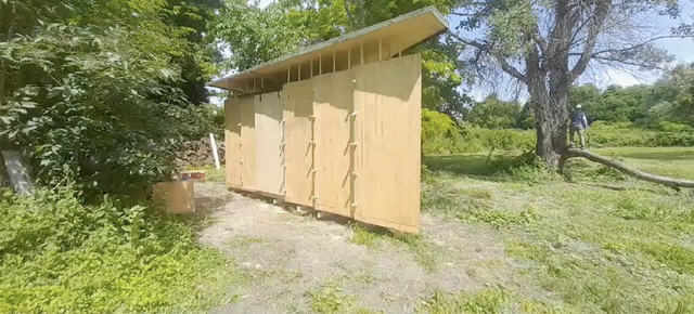 Picture of a small wooden building in a park.