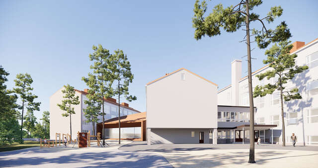 Kuva koulun pihasta, jossa on puita sekä useampi koulurakennus.