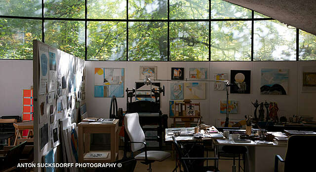 an office room with the sun shining in through the window