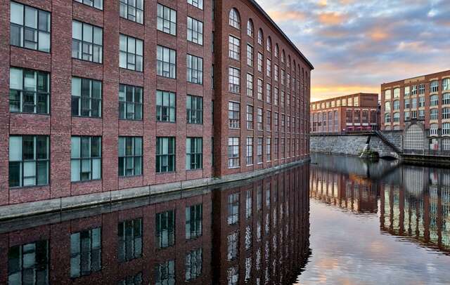 Red-brick industrial buildings along a river
