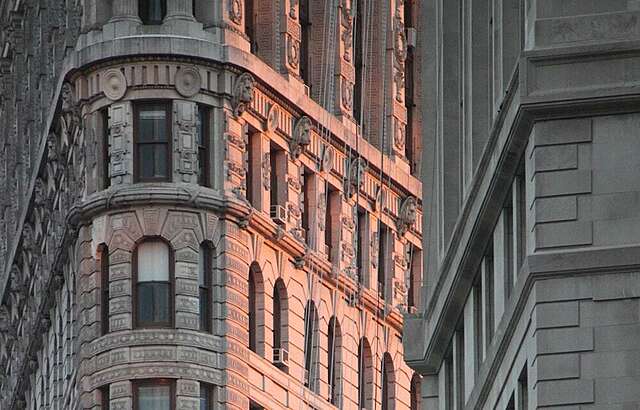Close-up of the façade of an apartment building with the sun shining on it.