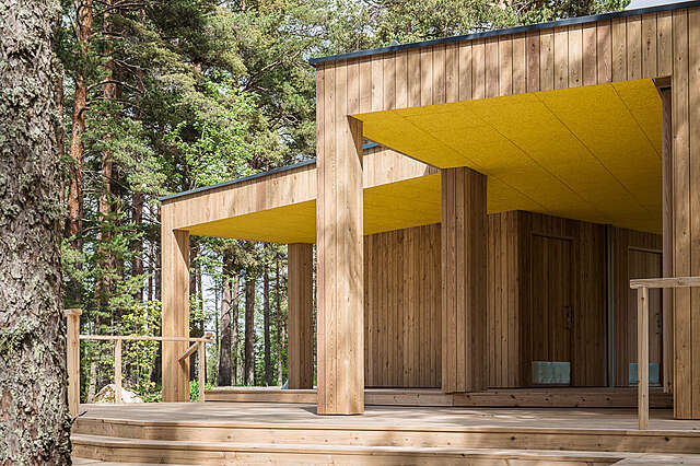 Wooden building, terrace and shed in the forest