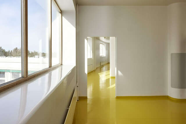 Corridor with bright yellow floors.