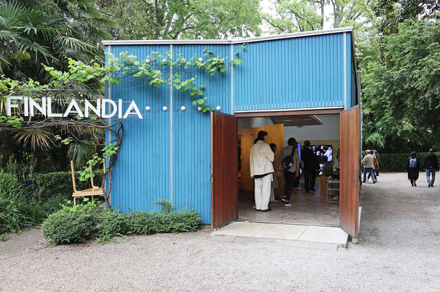 Blue wooden pavilion with people inside