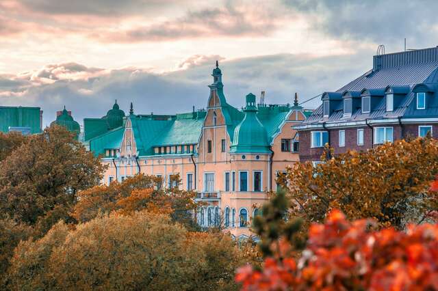 Old stone apartment buildings in an autumn landscape