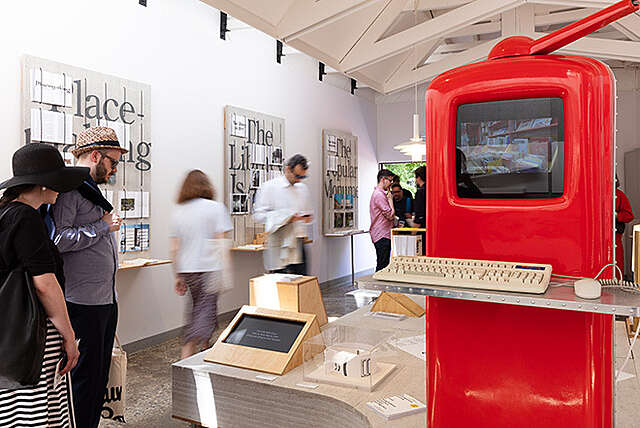 Kuva paviljongista, oikealla etualalla kirkkaan punainen tietokone