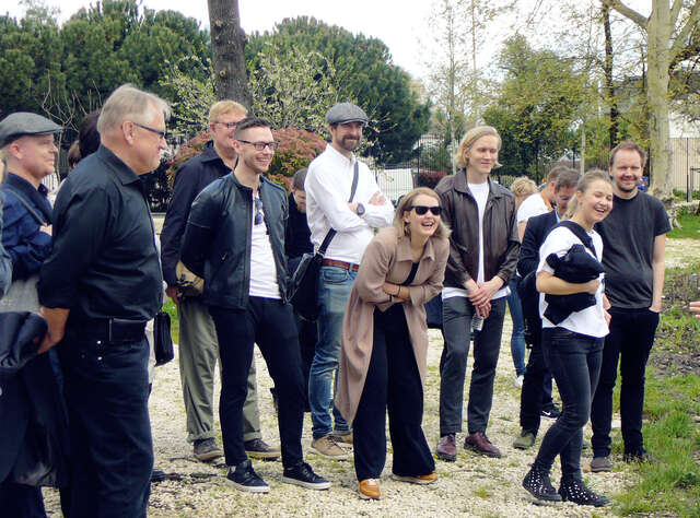 A bunch of laughing people in a park environment.