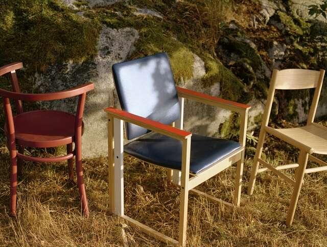 Different chairs in grass.