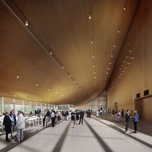 Havainnekuvassa on iso aula, jossa on kaareva katto. Tilassa on paljon ihmisiä.