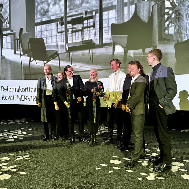 Group of people in front of the big screen