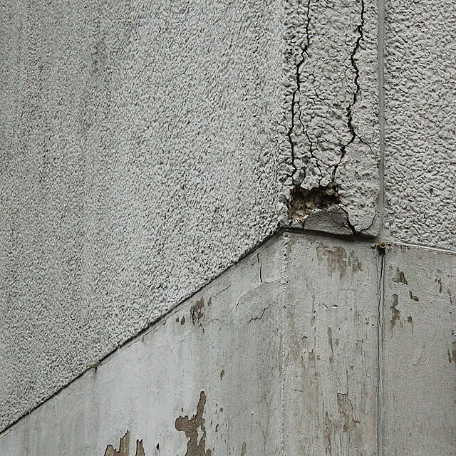 Photo of a crumbling corner of a building.