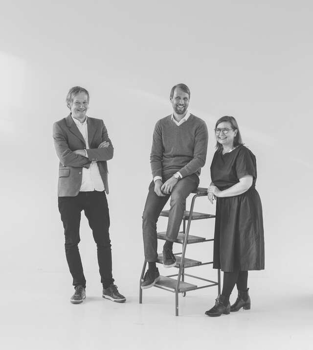 Three people in a studio.