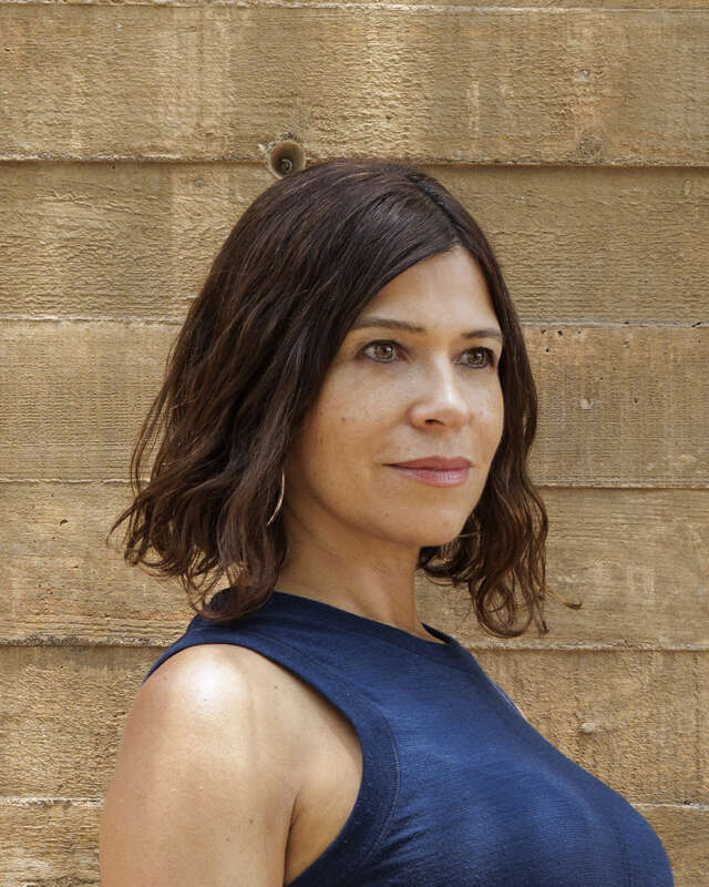 Woman who is standing behind the wall