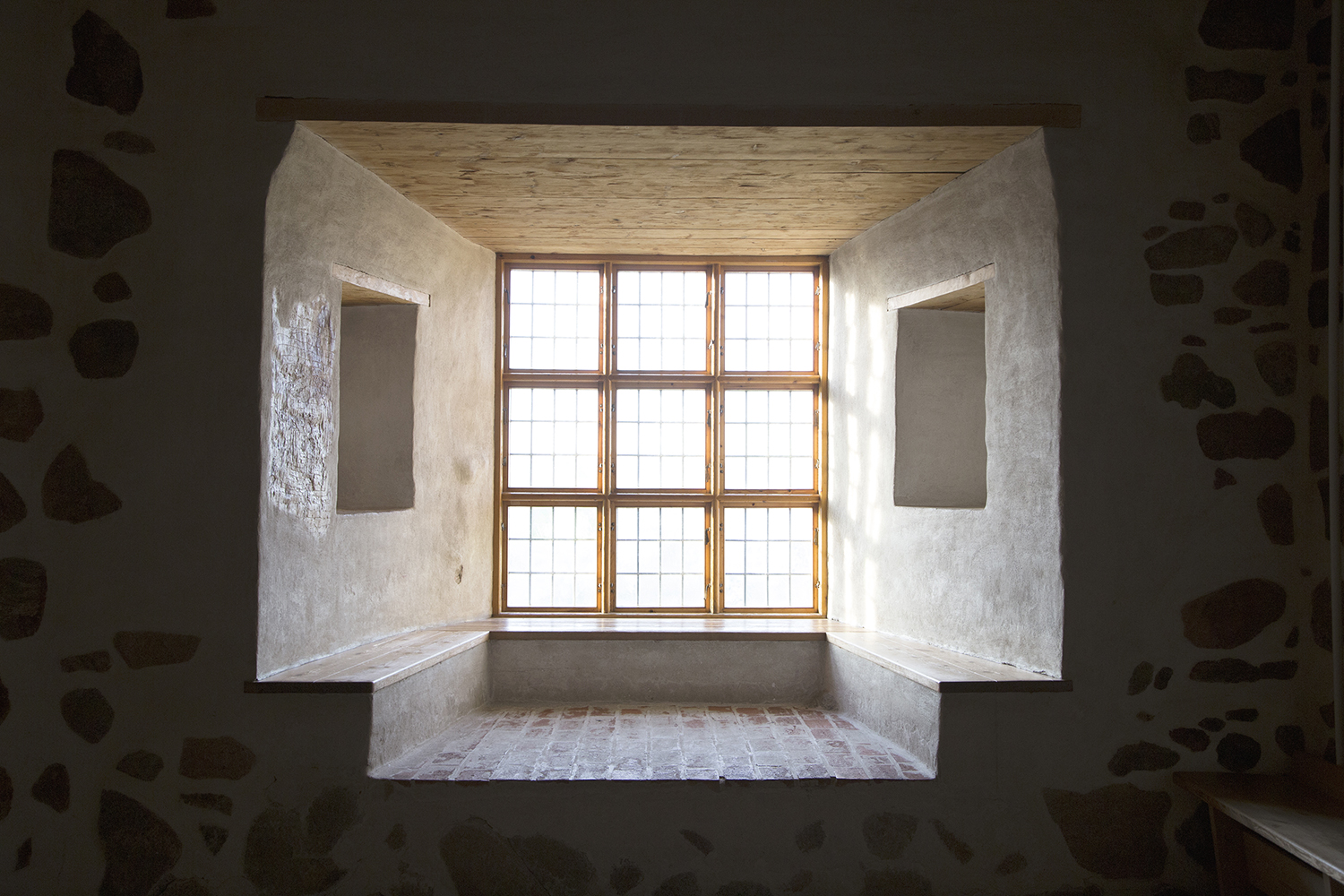 A window niche in a thick stone wall