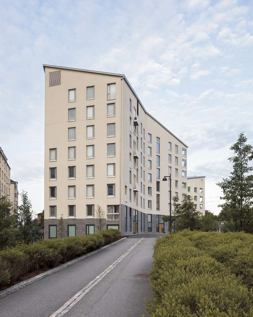 Kampin Helmi is cream-colored, sloping-roofed apartment building that is narrow and winding.