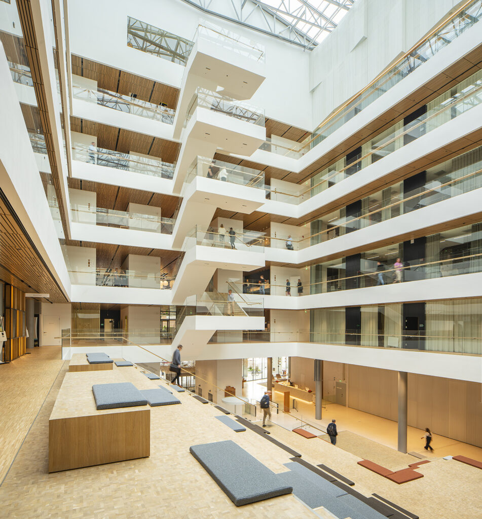 High atrium space, wooden floors, white walls, skylight