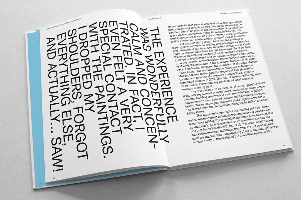 Open book, white spread with text, on the left page capital letter words vertically.